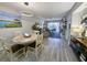 Bright dining area with table and chairs, open to living room at 478 Pinehurst Ln. # 17F, Pawleys Island, SC 29585