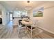 Dining area with four chairs and view into kitchen and living room at 478 Pinehurst Ln. # 17F, Pawleys Island, SC 29585