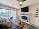 Living room with fireplace, balcony access, and comfortable seating at 478 Pinehurst Ln. # 17F, Pawleys Island, SC 29585