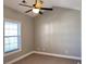 Bright bedroom with window, ceiling fan, and neutral walls at 4860 Carnation Circle # 304, Myrtle Beach, SC 29579