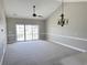 Spacious living room with vaulted ceiling, carpet, and access to balcony at 4860 Carnation Circle # 304, Myrtle Beach, SC 29579