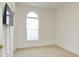 Bright bedroom features a large arched window and neutral carpeting at 5011 Harvest Dr. # 101, Myrtle Beach, SC 29579
