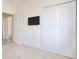 Bedroom includes TV mount, neutral carpet, and access to additional rooms and closets at 5011 Harvest Dr. # 101, Myrtle Beach, SC 29579