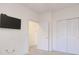 Neutral bedroom features a wall mounted TV, doors, and sliding door closets at 5011 Harvest Dr. # 101, Myrtle Beach, SC 29579