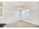 Bright dining room with chandelier, large window, and neutral carpeting at 5011 Harvest Dr. # 101, Myrtle Beach, SC 29579