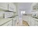 Kitchen featuring granite countertops, white cabinets, and view into dining area at 5011 Harvest Dr. # 101, Myrtle Beach, SC 29579
