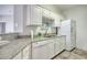 Bright kitchen with granite countertops, white cabinets, and modern appliances at 5011 Harvest Dr. # 101, Myrtle Beach, SC 29579