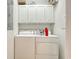 Functional laundry room equipped with a washer, dryer, and overhead storage cabinets at 5011 Harvest Dr. # 101, Myrtle Beach, SC 29579