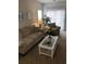 Cozy living room with plush sofa, armchair, and bright windows with blinds at 5011 Harvest Dr. # 101, Myrtle Beach, SC 29579