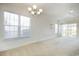Bright living room with large windows, ceiling fan, and sliding glass door to patio at 5011 Harvest Dr. # 101, Myrtle Beach, SC 29579