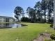 Scenic view of a pond and surrounding lawns at 5011 Harvest Dr. # 101, Myrtle Beach, SC 29579