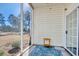 Cozy screened in porch with view of wooded area, features neutral décor and stylish accents at 5011 Harvest Dr. # 101, Myrtle Beach, SC 29579