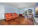 Living room with orange couch and hardwood floors at 534 Juniper Dr. # 534, Myrtle Beach, SC 29577
