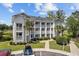 Two-story building with multiple units, balconies, and landscaping; view of golf course at 565 White River Dr. # 10-E, Myrtle Beach, SC 29579