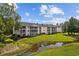 Exterior view of building with pond view at 565 White River Dr. # 10-E, Myrtle Beach, SC 29579