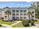 Two-story building with multiple units, balconies, and landscaping at 565 White River Dr. # 10-E, Myrtle Beach, SC 29579