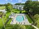 Community pool with adjacent hot tub and lounge chairs at 565 White River Dr. # 10-E, Myrtle Beach, SC 29579