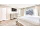 Main bedroom with large TV, dresser, and sliding glass doors to backyard at 5816 Woodside Ave., Myrtle Beach, SC 29577