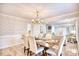 Bright dining room with elegant wallpaper, chandelier, and a view to the living room at 5816 Woodside Ave., Myrtle Beach, SC 29577