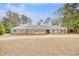 Brick home with landscaped yard and a circular driveway at 5816 Woodside Ave., Myrtle Beach, SC 29577