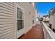 Exterior image of a back deck with ample space, accessible through a screen door and windows on the upper level at 6001- P04 S Kings Highway, Myrtle Beach, SC 29575