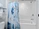 Updated bathroom with tub, shower, and a beach-themed shower curtain at 603 S Ocean Blvd. # 1103, North Myrtle Beach, SC 29582