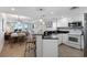Modern kitchen with white cabinets, granite countertops, and stainless steel appliances at 603 S Ocean Blvd. # 1103, North Myrtle Beach, SC 29582