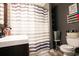 Clean bathroom with shower/tub and striped curtain at 606 Britt St., Georgetown, SC 29440