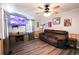 Living room with brown couch, wood-look floors and a large TV at 606 Britt St., Georgetown, SC 29440