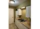 Kitchen features white cabinets, double sink, and appliances at 615 Carter Ln. # B4, Conway, SC 29526