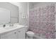 Bathroom with white vanity, floral shower curtain, and toilet at 654 Wallace Dr., Little River, SC 29566