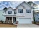 Two-story house with light-colored siding, brick accents, and a two-car garage at 7010 Shooting Star Way, Myrtle Beach, SC 29579
