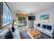 Virtually staged living room with two sofas and access to balcony at 7700 Porcher Dr. # 4202, Myrtle Beach, SC 29572