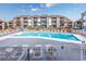 Community swimming pool with lounge chairs at 7700 Porcher Dr. # 4202, Myrtle Beach, SC 29572