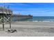 Relaxing beach scene with pier in background at 81 Delray Dr. # 2-C, Murrells Inlet, SC 29576