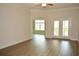 Bright living room with hardwood floors and access to a private balcony at 81 Delray Dr. # 2-C, Murrells Inlet, SC 29576