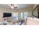 Bright living room with access to patio, featuring comfortable seating and a large TV at 81 Delray Dr. # 3-B, Murrells Inlet, SC 29576
