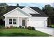 Charming one-story home with gray siding, white trim, and a two-car garage at 8712 High Banks Way, Longs, SC 29568