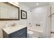 Stylish bathroom with navy vanity, framed mirror, and shower/tub combination at 899 Kinlaw Ln., Conway, SC 29527