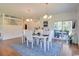 Elegant dining room with a modern table, stylish chairs, wood floors, and backyard views at 899 Kinlaw Ln., Conway, SC 29527