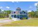 Stunning exterior of blue home with unique architectural design, white trim, and a spacious front yard at 899 Kinlaw Ln., Conway, SC 29527