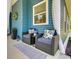 Inviting front porch with wicker seating, floral cushions, and a blue patterned rug at 899 Kinlaw Ln., Conway, SC 29527