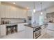 Bright kitchen features custom white cabinetry, granite countertops, stainless steel appliances, and tile flooring at 899 Kinlaw Ln., Conway, SC 29527