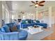Bright and airy living room with a large blue sofa, hardwood floors, and staircase at 899 Kinlaw Ln., Conway, SC 29527