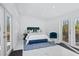 Bright bedroom with doors to the outside, stylish decor, and a comfortable bed at 899 Kinlaw Ln., Conway, SC 29527
