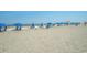 Beach with blue umbrellas and chairs on the sand at 1105 S Ocean Blvd. # 252, Myrtle Beach, SC 29577