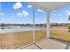 Screened porch with views of a tranquil pond with fountain, providing a relaxing outdoor living space at 1199 Pyxie Moss Dr., Little River, SC 29566