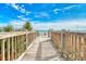 Wood boardwalk leading to a sandy beach with clear blue skies and ocean views at 1207 S Ocean Blvd. # 20701, Myrtle Beach, SC 29577