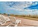 Sunny beach view with rows of white lounge chairs and grassy dunes leading to the ocean at 1207 S Ocean Blvd. # 20701, Myrtle Beach, SC 29577