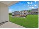 Expansive backyard with lush green grass and views of neighboring homes, perfect for outdoor activities and relaxation at 1208 Nw Calabash Station Blvd., Calabash, NC 28467